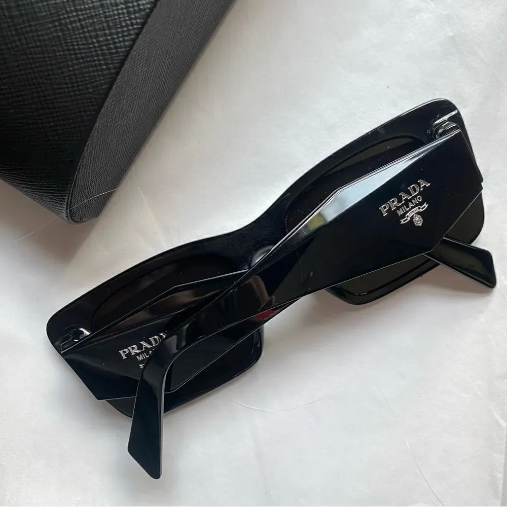 Prada Eyewear black square frame sunglasses logo sides Revolve in case $489